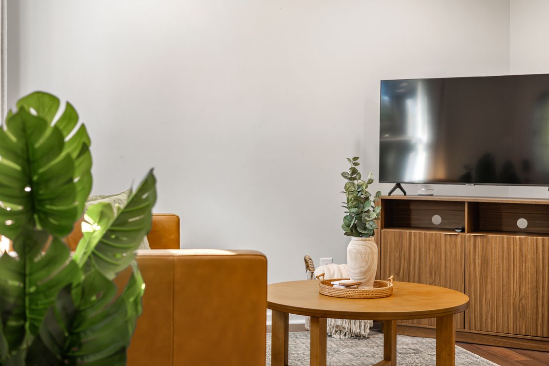 Flat-screen TV on a stand in a living room